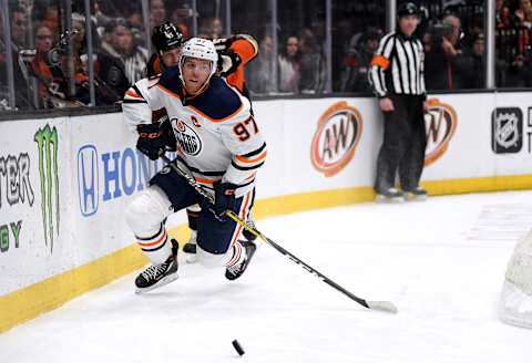 ANAHEIM, CALIFORNIA – FEBRUARY 25: Connor McDavid #97 of the Edmonton Oilers is knocked off balance by Ryan Getzlaf #15 of the Anaheim Ducks during the second period at Honda Center on February 25, 2020 in Anaheim, California. (Photo by Harry How/Getty Images)