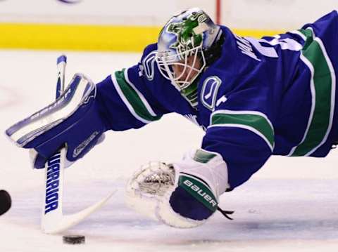 Jan 1, 2016; Vancouver, British Columbia, CAN; Vancouver Canucks goaltender Jacob Markstrom (25) reaches for the puck after a shot by the Anaheim Ducks during the first period at Rogers Arena. Mandatory Credit: Anne-Marie Sorvin-USA TODAY Sports