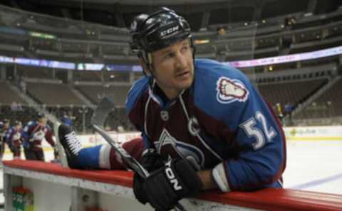 DENVER – SEPTEMBER 22: Adam Foote #52, captain of the Colorado Avalanche, stretches during warm up prior to facing the Los Angeles Kings during preseason NHL action at the Pepsi Center on September 22, 2010 in Denver, Colorado. The Kings defeated the Avalanche 4-2. (Photo by Doug Pensinger/Getty Images)