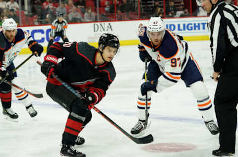 RALEIGH, NC – FEBRUARY 15: Sebastian Aho #20 of the Carolina Hurricanes wins a faceoff against Connor McDavid #97 of the Edmonton Oilers during an NHL game on February 15, 2019 at PNC Arena in Raleigh, North Carolina. (Photo by Gregg Forwerck/NHLI via Getty Images)