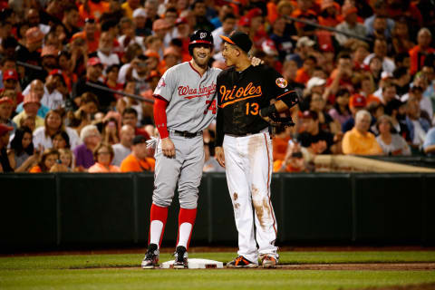 BALTIMORE, MD – JULY 10: Bryce Harper #34 of the Washington Nationals and Manny Machado #13 of the Baltimore Orioles talk during their game at Oriole Park at Camden Yards on July 10, 2015 in Baltimore, Maryland. (Photo by Rob Carr/Getty Images)