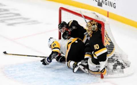 Jan 26, 2021; Boston, Massachusetts, USA; Pittsburgh Penguins left wing Jason Zucker (16) and Boston Bruins defenseman Jeremy Lauzon (55) crash into the net along with goaltender Tuukka Rask (40) during the second period at the TD Garden. Mandatory Credit: Brian Fluharty-USA TODAY Sports