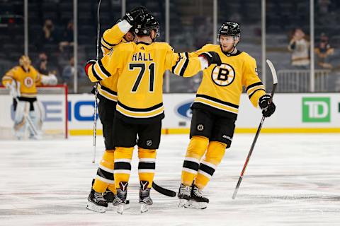 BOSTON, MASSACHUSETTS – APRIL 15: Taylor Hall #71 of the Boston Bruins celebrates with Jeremy Lauzon #55 and Patrice Bergeron #37 after scoring a goal against the New York Islanders during the third period at TD Garden on April 15, 2021 in Boston, Massachusetts. The Bruins defeat the Islanders 4-1. (Photo by Maddie Meyer/Getty Images)