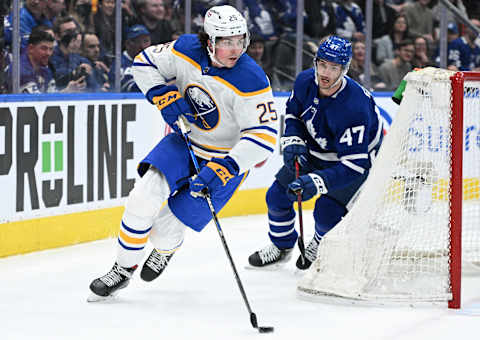 Apr 12, 2022; Toronto, Ontario, CAN; Buffalo Sabres defenseman Owen Power (25) skates the puck away from Toronto Maple Leafs forward Pierre Engvall (47) in the first period at Scotiabank Arena. Mandatory Credit: Dan Hamilton-USA TODAY Sports