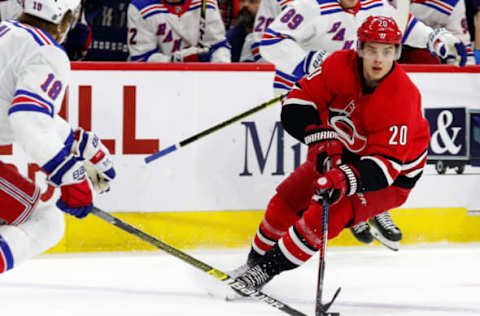 RALEIGH, NC – FEBRUARY 19: Sebastian Aho #20 of the Carolina Hurricanes avoids Marc Staal #18 of the New York Rangers during an NHL game on February 19, 2019 at PNC Arena in Raleigh, North Carolina. (Photo by Karl DeBlaker/NHLI via Getty Images)