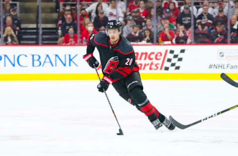 Jun 1, 2021; Raleigh, North Carolina, USA; Carolina Hurricanes right wing Sebastian Aho (20) skates with the puck against the Tampa Bay Lightning in game two of the second round of the 2021 Stanley Cup Playoffs at PNC Arena. Mandatory Credit: James Guillory-USA TODAY Sports