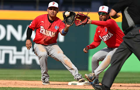 Jonathan Araúz (right) of Team Panama turns a game-ending double play Saturday against Italy. (Photo by Gene Wang/Getty Images)