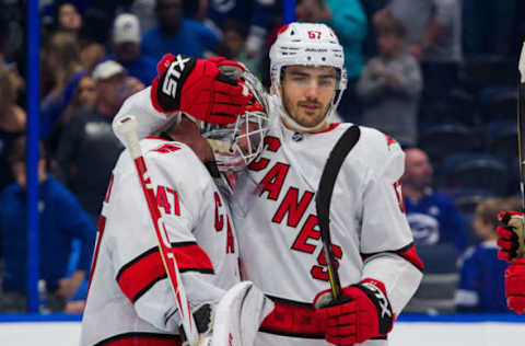 TAMPA, FL – NOVEMBER 30: Goalie James Reimer #47 and Trevor van Riemsdyk #57 of the Carolina Hurricanes celebrate the win against the Tampa Bay Lightning during the third period at Amalie Arena on November 30, 2019 in Tampa, Florida. (Photo by Scott Audette /NHLI via Getty Images)