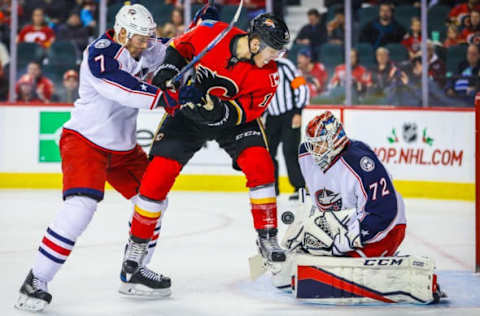 Dec 16, 2016; Calgary, Alberta, CAN; Columbus Blue Jackets goalie Sergei Bobrovsky (72) makes a save as Calgary Flames left wing Matthew Tkachuk (19) and Columbus Blue Jackets defenseman Jack Johnson (7) battle for the puck during the first period at Scotiabank Saddledome. Mandatory Credit: Sergei Belski-USA TODAY Sports