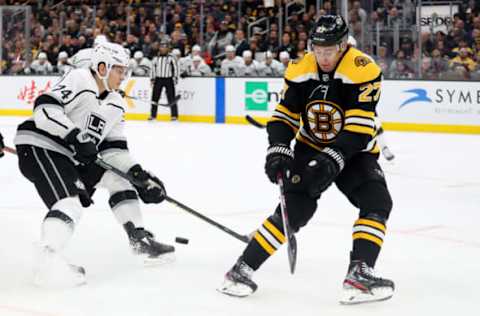 BOSTON, MASSACHUSETTS – DECEMBER 17: John Moore #27 of the Boston Bruins defends Nikolai Prokhorkin #74 of the Los Angeles Kings during the second period at TD Garden on December 17, 2019 in Boston, Massachusetts. (Photo by Maddie Meyer/Getty Images)