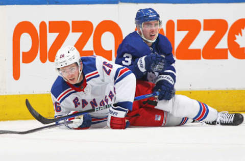 TORONTO, CANADA – JANUARY 25: Jimmy Vesey #26 of the New York Rangers collides with Justin Holl #3 of the Toronto Maple Leafs during an NHL game at Scotiabank Arena on January 25, 2023, in Toronto, Ontario, Canada. The Maple Leafs defeated the Rangers 3-2 in overtime. (Photo by Claus Andersen/Getty Images)