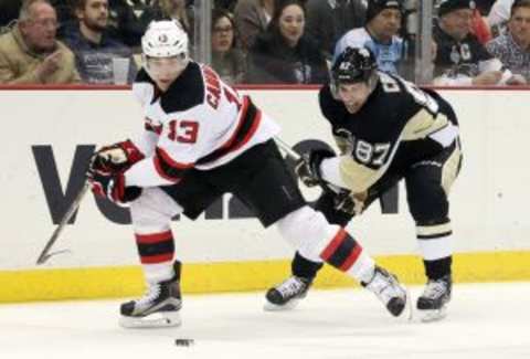 Jan 26, 2016; Pittsburgh, PA, USA; New Jersey Devils left wing Michael Cammalleri (13) chases the puck against Pittsburgh Penguins center Sidney Crosby (87) during the second period at the CONSOL Energy Center. Mandatory Credit: Charles LeClaire-USA TODAY Sports