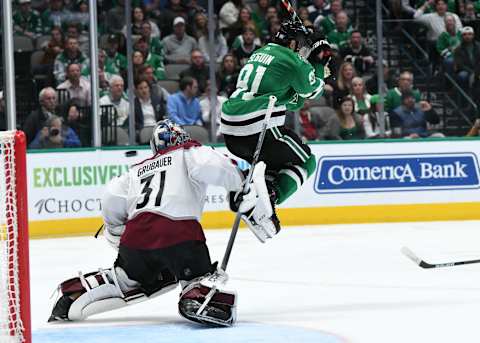 DALLAS, TX – NOVEMBER 5: Tyler Seguin #91 of the Dallas Stars tries to jump out of the way of a puck against Philipp Grubauer #31 of the Colorado Avalanche at the American Airlines Center on November 5, 2019 in Dallas, Texas. (Photo by Glenn James/NHLI via Getty Images)