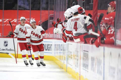 Mar 16, 2021; Detroit, Michigan, USA; Carolina Hurricanes center Sebastian Aho (20) celebrates with teammates after scoring a goal against the Detroit Red Wings during the second period at Little Caesars Arena. Mandatory Credit: Tim Fuller-USA TODAY Sports