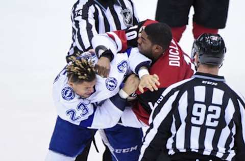 Mar 19, 2016; Glendale, AZ, USA; Arizona Coyotes left wing Anthony Duclair (10) and Tampa Bay Lightning right wing J.T. Brown (23) fight during the third period at Gila River Arena. Mandatory Credit: Matt Kartozian-USA TODAY Sports