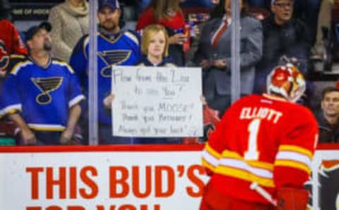 Oct 22, 2016; Calgary, Alberta, CAN; St. Louis Blues fans holding a sign in front of Calgary Flames goalie Brian Elliott (1) during the warmup period against St. Louis Blues at Scotiabank Saddledome. Mandatory Credit: Sergei Belski-USA TODAY Sports