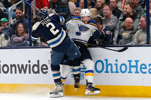 Mar 11, 2023; Columbus, Ohio, USA; Columbus Blue Jackets defenseman Andrew Peeke (2) checks St. Louis Blues defenseman Marco Scandella (6) during the second period at Nationwide Arena. Mandatory Credit: Russell LaBounty-USA TODAY Sports