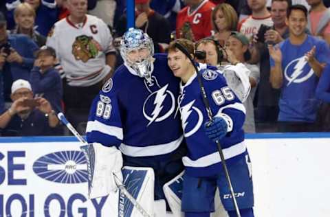 Mar 27, 2017; Tampa, FL, USA; Tampa Bay Lightning center Yanni Gourde (65) celebrates with goalie Andrei Vasilevskiy (88) after scoring the game winning goal during overtime against the Chicago Blackhawks at Amalie Arena. The Lightning won 5-4 in overtime. Mandatory Credit: Kim Klement-USA TODAY Sports