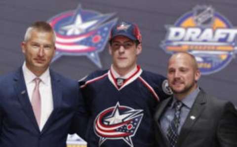 Jun 24, 2016; Buffalo, NY, USA; Pierre-Luc Dubois poses for a photo with team officials after being selected as the number three overall draft pick by the Columbus Blue Jackets in the first round of the 2016 NHL Draft at the First Niagra Center. Mandatory Credit: Timothy T. Ludwig-USA TODAY Sports