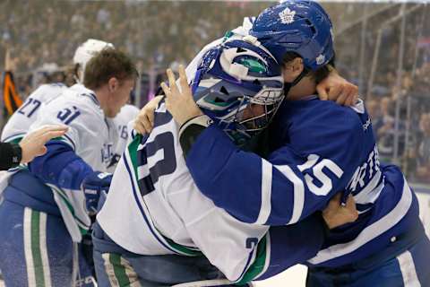 TORONTO, ON – NOVEMBER 5: Toronto Maple Leafs left wing Matt Martin (15) is grabbed by Vancouver Canucks goalie Ryan Miller (30) who then gets into the fight action. Toronto Maple Leafs V Vancouver Canucks during3rd period action in NHL regular season play at the Air Canada Centre. Leafs won 6-3. Toronto Star/Rick Madonik (Rick Madonik/Toronto Star via Getty Images)