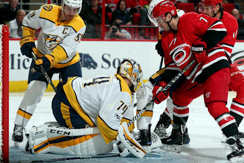 RALEIGH, NC – NOVEMBER 26: Derek Ryan #7 of the Carolina Hurricanes digs for a puck covered by Juuse Saros #74 of the Nashville Predators during an NHL game on November 26, 2017 at PNC Arena in Raleigh, North Carolina. (Photo by Gregg Forwerck/NHLI via Getty Images)