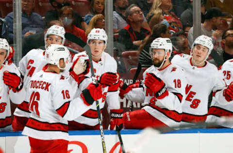 SUNRISE, FL – NOVEMBER 6: Teammates congratulate Vincent Trocheck #16 of the Carolina Hurricanes after he scored a second-period goal against the Florida Panthers at the FLA Live Arena on November 6, 2021, in Sunrise, Florida. (Photo by Joel Auerbach/Getty Images)