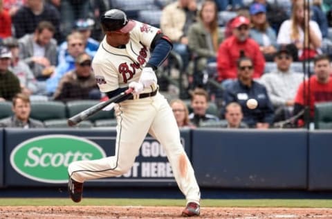 Apr 10, 2016; Atlanta, GA, USA; Atlanta Braves left fielder Hector Olivera (28) hits a RBI sacrifice fly against the St. Louis Cardinals during the fifth inning at Turner Field. Mandatory Credit: Dale Zanine-USA TODAY Sports