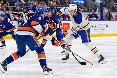 Mar 7, 2023; Elmont, New York, USA; Buffalo Sabres defenseman Owen Power (25) shoots against New York Islanders defenseman Noah Dobson (8) during the third period at UBS Arena. Mandatory Credit: Dennis Schneidler-USA TODAY Sports