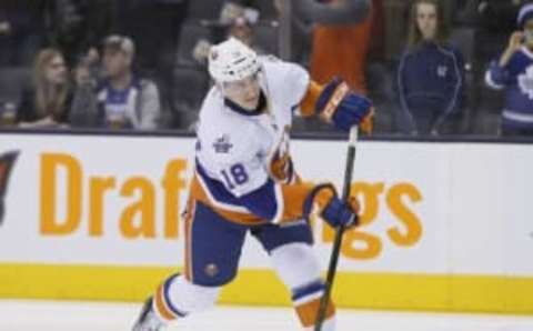 Mar 9, 2016; Toronto, Ontario, CAN; New York Islanders forward Ryan Strome (18) shoots the puck prior to the game against the Toronto Maple Leafs at the Air Canada Centre. Mandatory Credit: John E. Sokolowski-USA TODAY Sports