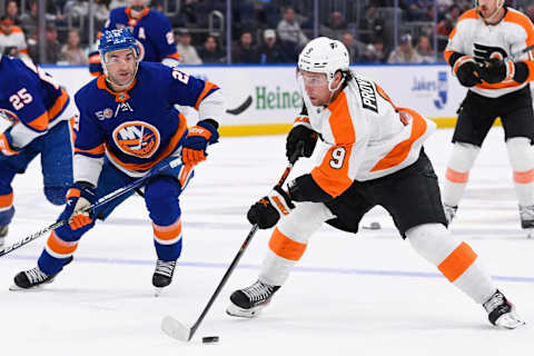 Apr 8, 2023; Elmont, New York, USA; Philadelphia Flyers defenseman Ivan Provorov (9) skates with the puck defended by New York Islanders center Kyle Palmieri (21) during the first period at UBS Arena. Mandatory Credit: Dennis Schneidler-USA TODAY Sports