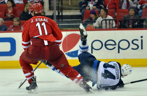 RALEIGH, NC – FEBRUARY 04: Zach Bogosian #44 of the Winnipeg Jets falls while defending Jordan Staal #11 of the Carolina Hurricanes at PNC Arena on February 4, 2013, in Raleigh, North Carolina. The Jets defeated the Hurricanes 2-1. (Photo by Lance King/Getty Images)