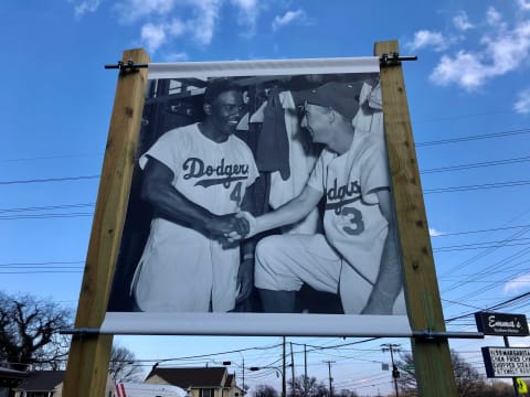 One of David Williams’ banners shows Black baseball pioneer Jackie Robinson and white Dodgers teammate Pee Wee Reese to draw a comparison to the racial harmony that also existed at the Pond Gap field.Pond Gap Field Pics 4