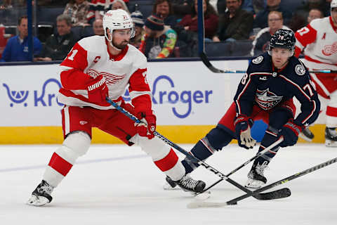 Oct 16, 2023; Columbus, Ohio, USA; Columbus Blue Jackets defenseman Damon Severson (78) defends against Detroit Red Wings center Dylan Larkin (71) during the first period at Nationwide Arena. Mandatory Credit: Russell LaBounty-USA TODAY Sports