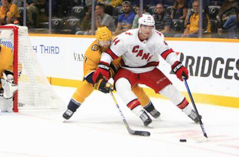 NASHVILLE, TN – SEPTEMBER 25: Hurricanes forward Julien Gauthier (44) shields the puck from Nashville Predators defenseman Ryan Ellis (4) during the NHL preseason game between the Nashville Predators and Carolina Hurricanes, held on September 25, 2019, at Bridgestone Arena in Nashville, Tennessee. (Photo by Danny Murphy/Icon Sportswire via Getty Images)