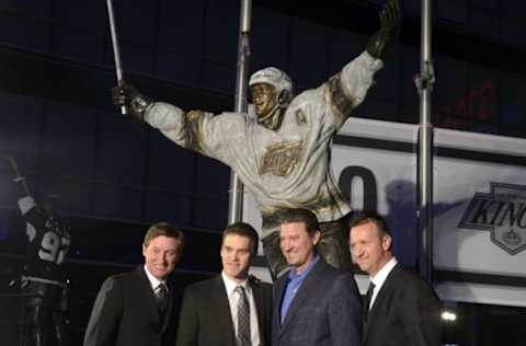 Mar 7, 2015; Los Angeles, CA, USA; Los Angeles Kings former player Luc Robitaille (second from left) poses with Wayne Gretzky (left) , Mario Lemieux (second from right) and Rob Blake at ceremony to unveil statue of Robitaille before the game against the Pittsburgh Penguins at Staples Center. Mandatory Credit: Kirby Lee-USA TODAY Sports