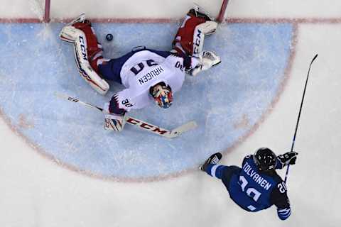 TOPSHOT – Finland’s Eeli Tolvanen (R) scores on Norway’s Lars Haugen in the men’s preliminary round ice hockey match between Finland and Norway during the Pyeongchang 2018 Winter Olympic Games at the Gangneung Hockey Centre in Gangneung on February 16, 2018. / AFP PHOTO / Brendan SMIALOWSKI (Photo credit should read BRENDAN SMIALOWSKI/AFP/Getty Images)