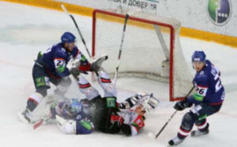 NOVOSIBIRSK, RUSSIA – DECEMBER 10: Goalkeeper Bernd Bruckler #30 of the Sibir collides with Alexander Bumagin #87 of the Metallurg in the crease during the KHL Championship 2011/2012 on December 10, 2011 at the Arena Sibir in Novosibirsk, Russia. The Metallurg defeated the Sibir 2-1. (Photo by Nina Semashko/KHL Photo Agency via Getty Images)