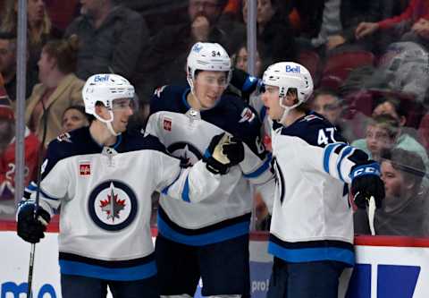 Winnipeg Jets, Brad Lambert (47), Logan Stanley (64), Ville Heinola (14). Mandatory Credit: Eric Bolte-USA TODAY Sports