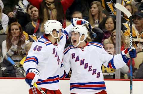 NHL Power Rankings: New York Rangers right wing Matt Puempel (12) celebrates his goal with left wing Marek Hrivik (46) against the Pittsburgh Penguins during the first period at the PPG PAINTS Arena. Mandatory Credit: Charles LeClaire-USA TODAY Sports