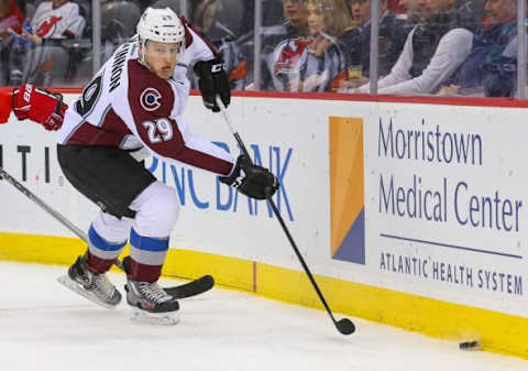 Dec 1, 2015; Newark, NJ, USA; Colorado Avalanche center Nathan MacKinnon (29) plays the puck along the boards during the first period of their game against the New Jersey Devils at Prudential Center. Mandatory Credit: Ed Mulholland-USA TODAY Sports