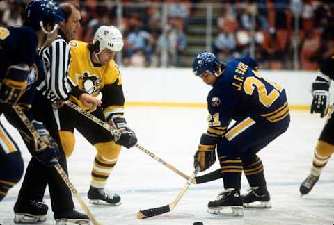 BUFFALO, NY – CIRCA 1981: Greg Malone #12 of the Pittsburgh Penguins faces off against J.F. Sauve #21 of the Buffalo Sabers during an NHL Hockey game circa 1981 at the Buffalo Memorial Auditorium in Buffalo, New York. Malone’s playing career went from 1976-87. (Photo by Focus on Sport/Getty Images)