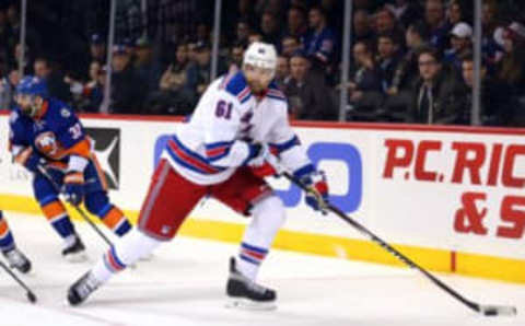 Jan 14, 2016; Brooklyn, NY, USA; New York Rangers left wing Rick Nash (61) controls the puck in front of New York Islanders defenseman Brian Strait (37) during the third period at Barclays Center. The Islanders defeated the Rangers 3-1. Mandatory Credit: Brad Penner-USA TODAY Sports