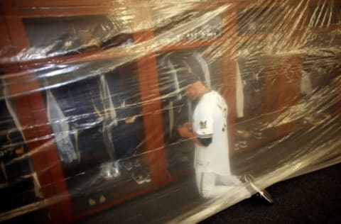 Kapler sends a text message in Milwaukee’s clubhouse after their Wild Card victory in 2008. Photo by Darren Hauck/Getty Images.