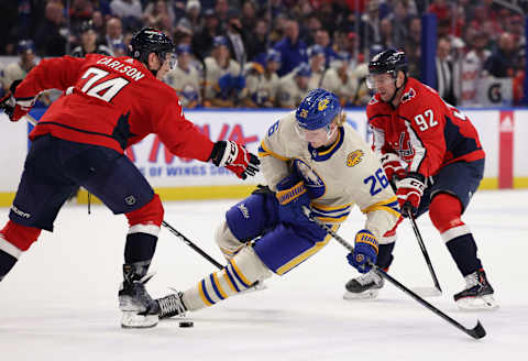 Mar 25, 2022; Buffalo, New York, USA; Washington Capitals defenseman John Carlson (74) knocks Buffalo Sabres defenseman Rasmus Dahlin (26) off the puck during the third period at KeyBank Center. Mandatory Credit: Timothy T. Ludwig-USA TODAY Sports