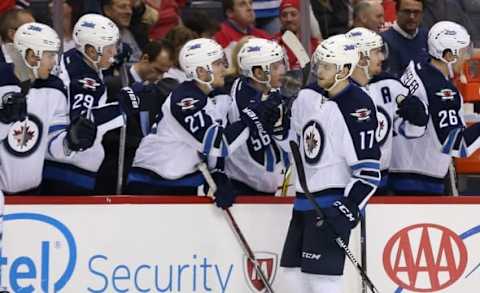 Nov 3, 2016; Washington, DC, USA; Winnipeg Jets center Adam Lowry (17) celebrates with teammates after scoring a goal against the Washington Capitals in the third period at Verizon Center. The Capitals won 4-3 in overtime. Mandatory Credit: Geoff Burke-USA TODAY Sports