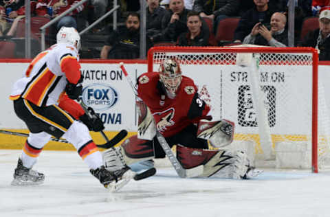 GLENDALE, AZ – FEBRUARY 22: Mark Jankowski #77 of the Calgary Flames slips the puck past goalie Antti Raanta #32 of the Arizona Coyotes for a goal during the third period at Gila River Arena on February 22, 2018 in Glendale, Arizona. (Photo by Norm Hall/NHLI via Getty Images)