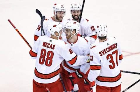 TORONTO, ONTARIO – AUGUST 13: Dougie Hamilton #19 of the Carolina Hurricanes is congratulated by his teammates after scoring a goal against the Boston Bruins during the third period in Game Two of the Eastern Conference First Round during the 2020 NHL Stanley Cup Playoffs at Scotiabank Arena on August 13, 2020, in Toronto, Ontario. (Photo by Elsa/Getty Images)