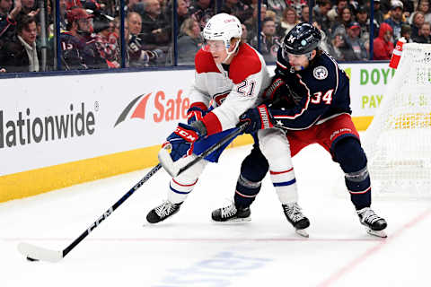 COLUMBUS, OHIO – NOVEMBER 17: Kaiden Guhle #21 of the Montreal Canadiens controls the puck against Cole Sillinger #34 of the Columbus Blue Jackets during the second period at Nationwide Arena on November 17, 2022 in Columbus, Ohio. (Photo by Emilee Chinn/Getty Images)