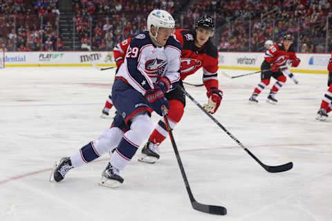 Oct 30, 2022; Newark, New Jersey, USA; Columbus Blue Jackets left wing Patrik Laine (29) skates with the puck while being defended by New Jersey Devils defenseman Ryan Graves (33) during the first period at Prudential Center. Mandatory Credit: Ed Mulholland-USA TODAY Sports