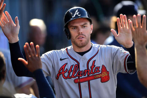 Oct 19, 2021; Los Angeles, California, USA; Atlanta Braves first baseman Freddie Freeman (5) celebrates with team mates after scoring in the fourth inning of game three of the 2021 NLCS against the Los Angeles Dodgers at Dodger Stadium. Mandatory Credit: Jayne Kamin-Oncea-USA TODAY Sports